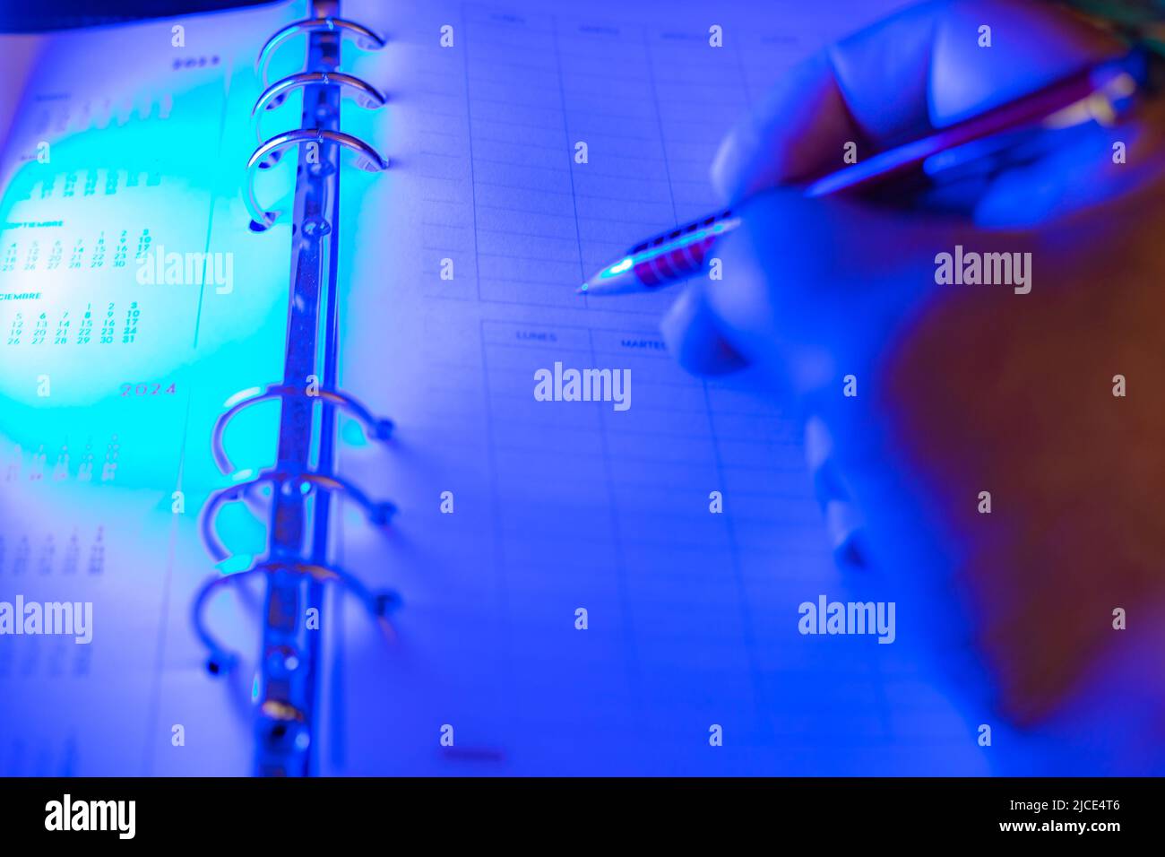businessman making notes in his diary with blue selective focus Stock Photo