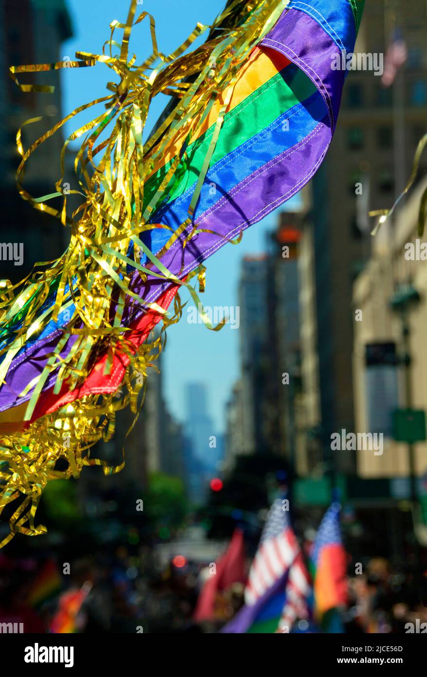 Rainbow flag and NYC streets during Pride March. Stock Photo