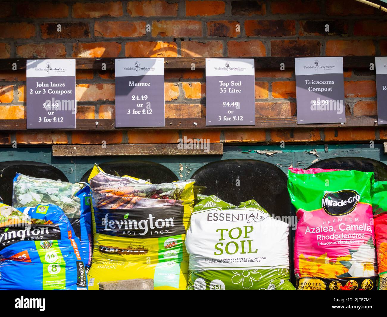 A display of bags of top Soil,  composts  in a garden centre Stock Photo
