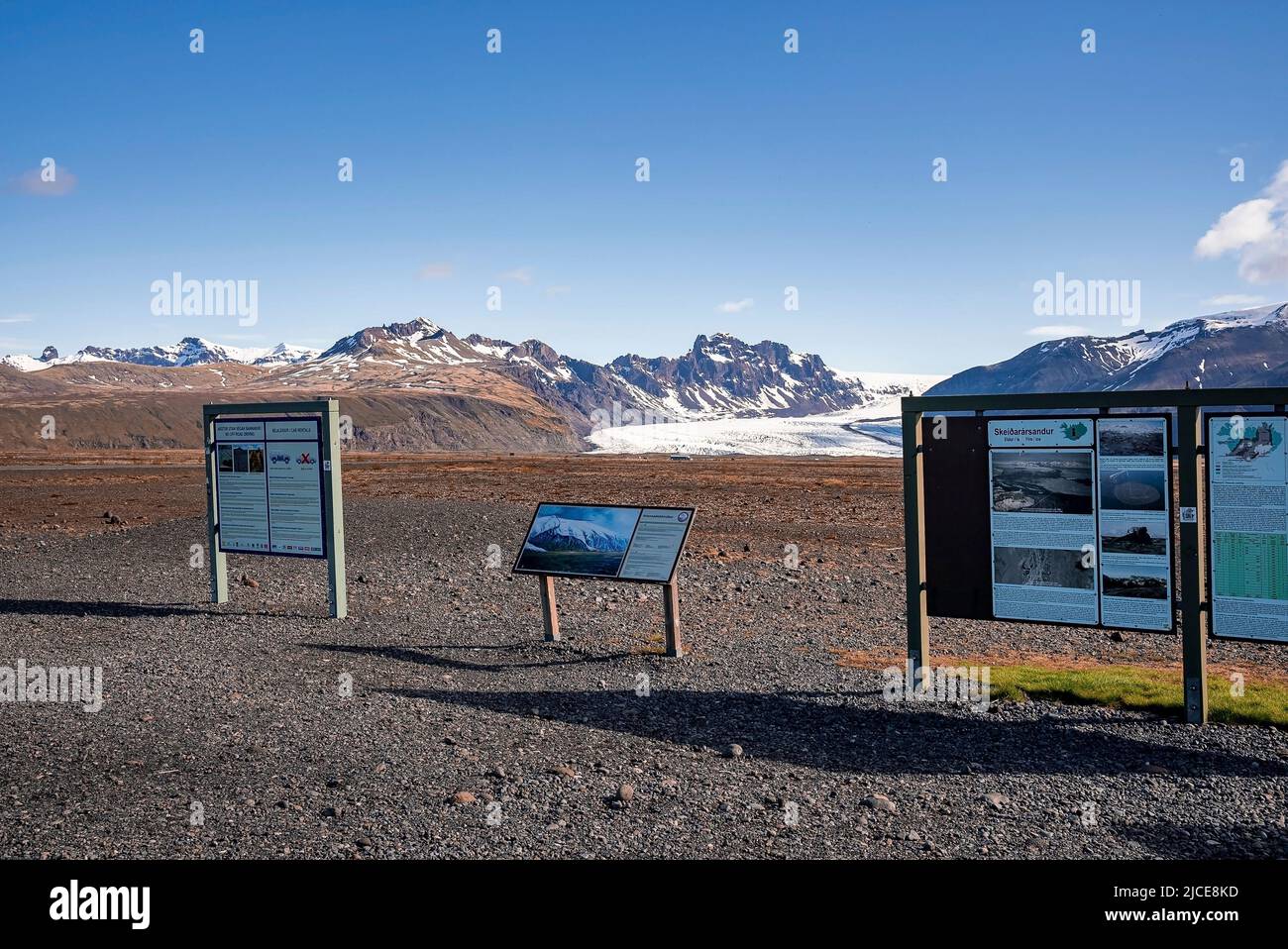 Information signboards with snowcapped mountains in background against sky Stock Photo