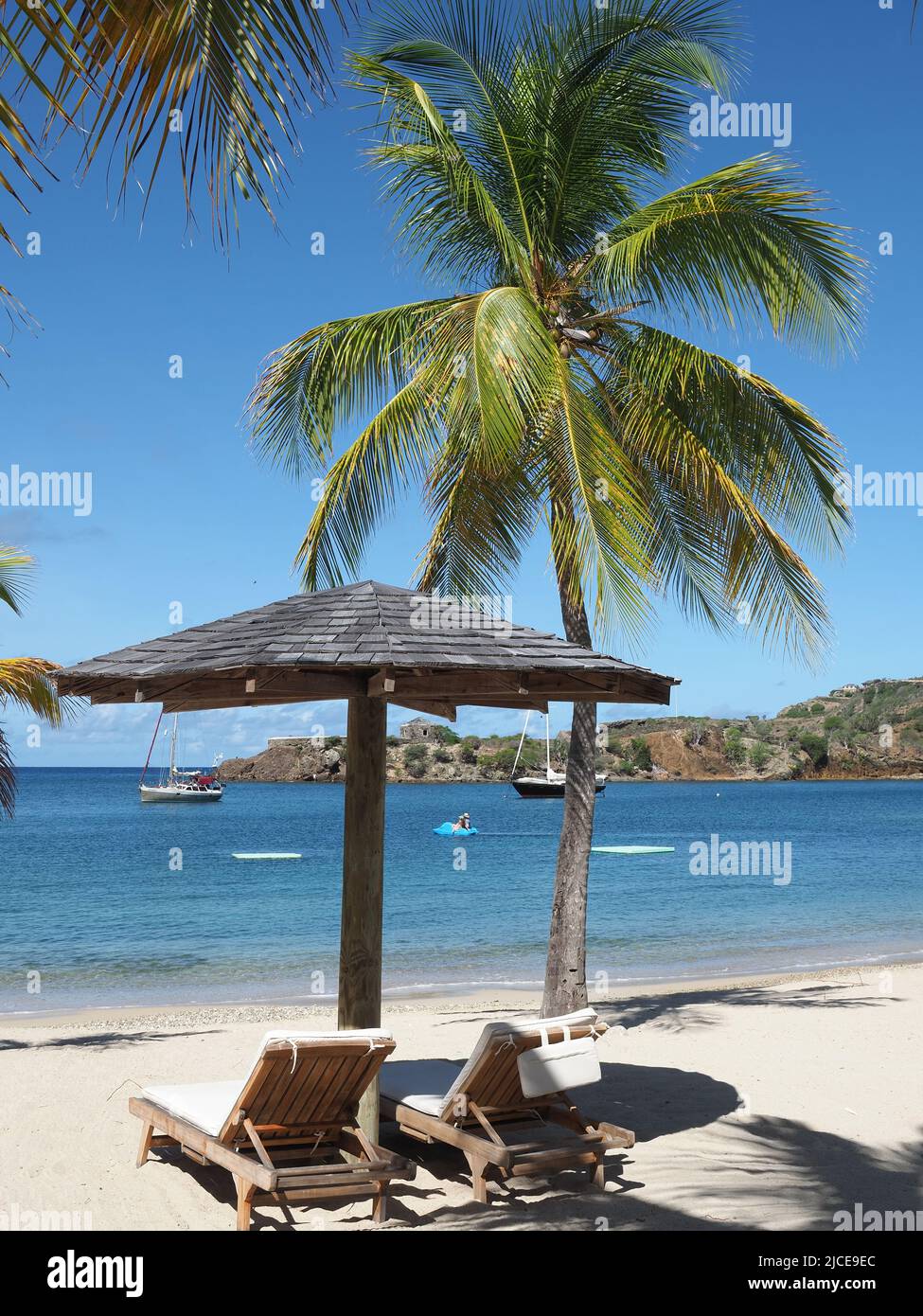 View along a beautiful sandy Caribbean beach in Antigua in the summer Stock Photo