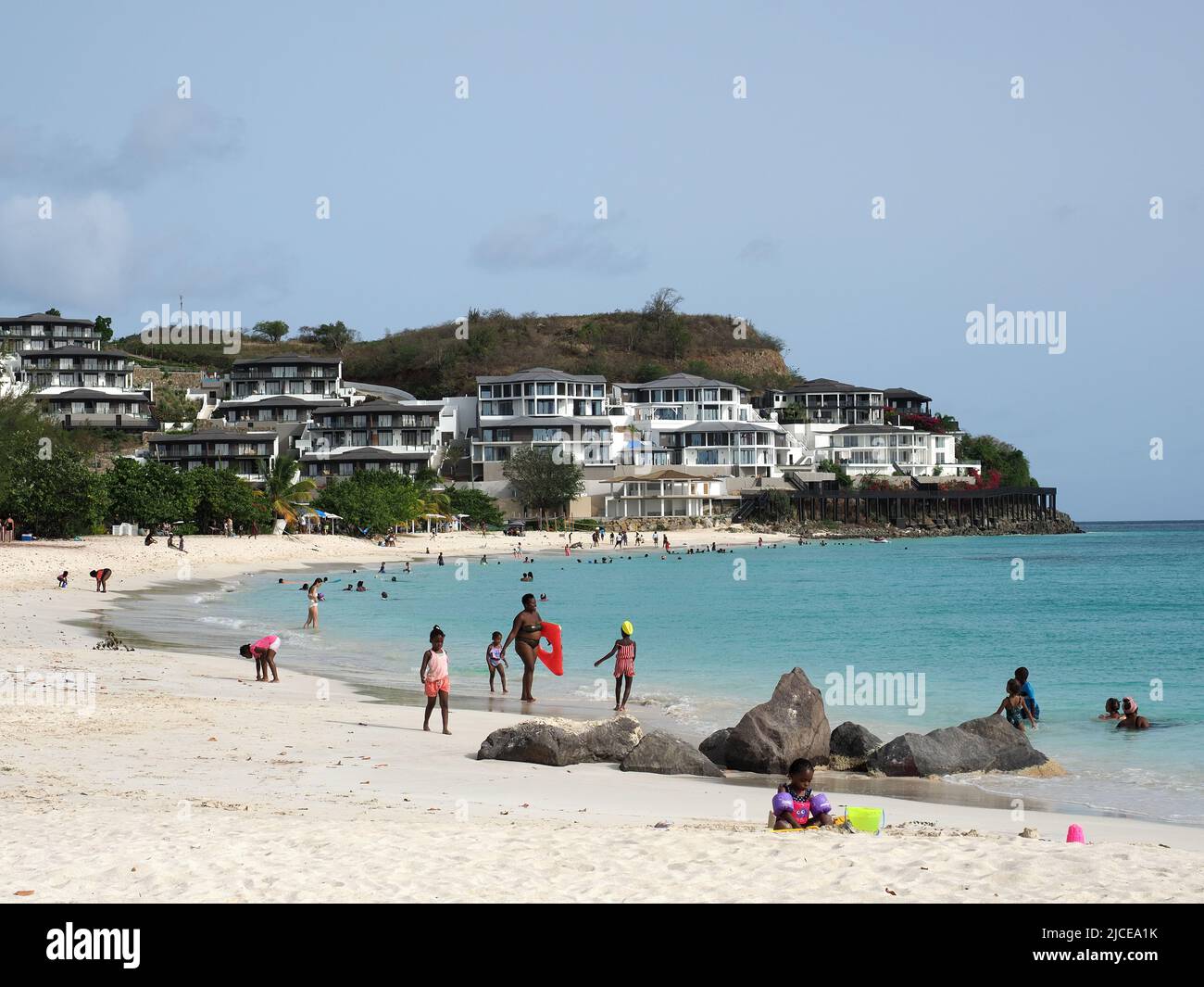 View along sandy Ffryes Beach in Antigua with the Tamarind Hills hotel resort in the background Stock Photo