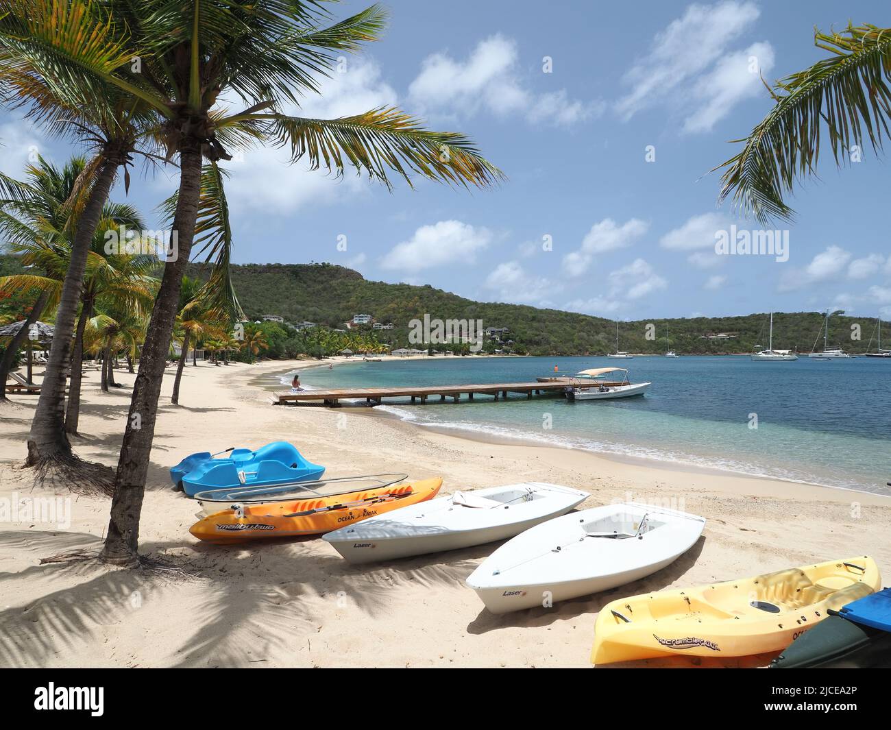 View along a beautiful sandy Caribbean beach in Antigua in the summer Stock Photo