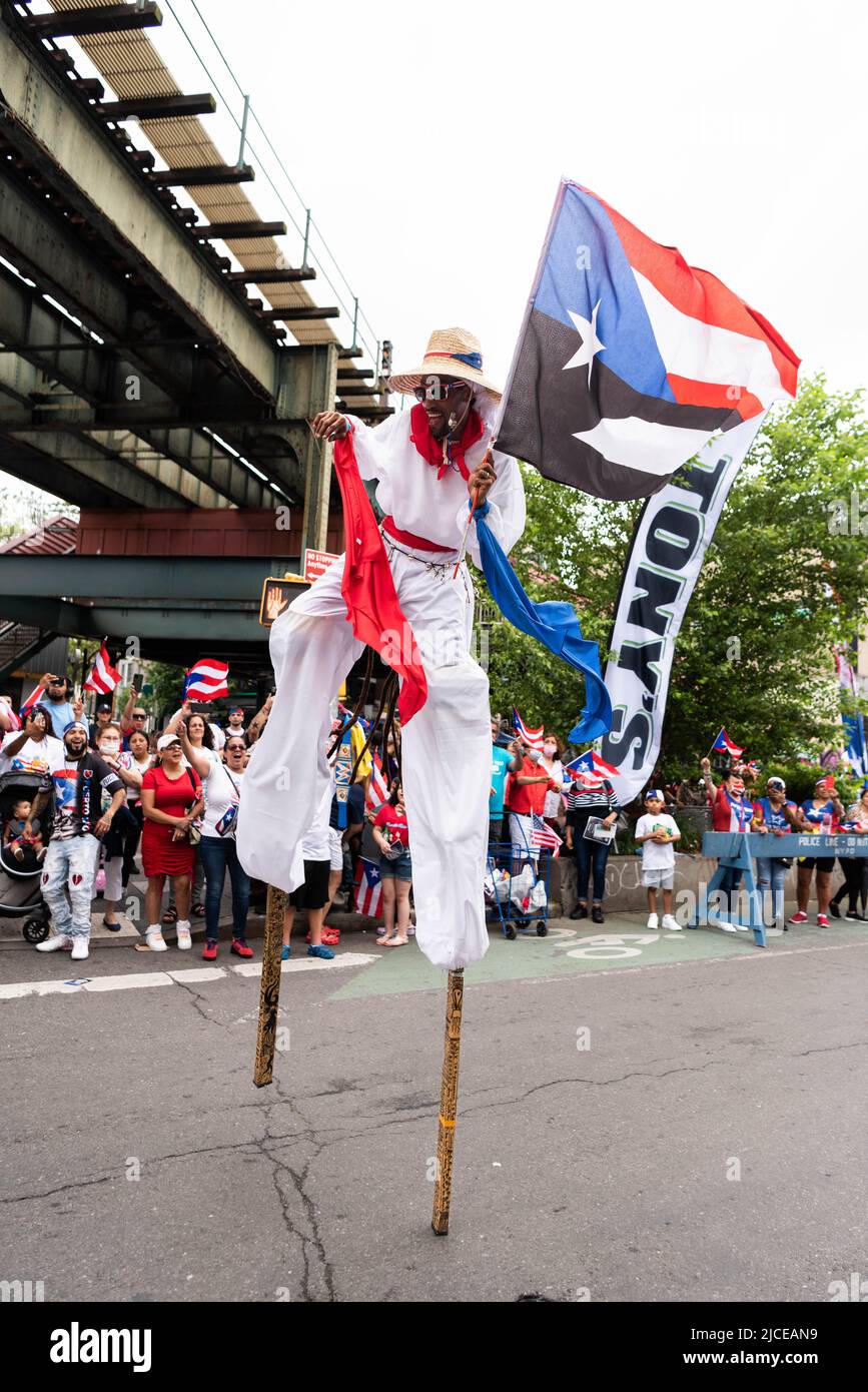 A man on stilts walks in the Puerto Rico Day Parade in Bushwick Brooklyn. Stock Photo