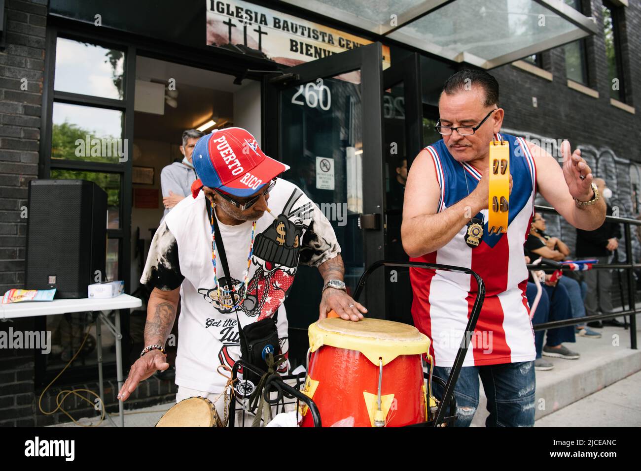 Attendees of the Bushwick Puerto Rico day parade celebrating and playing music after the parade finishes. Stock Photo