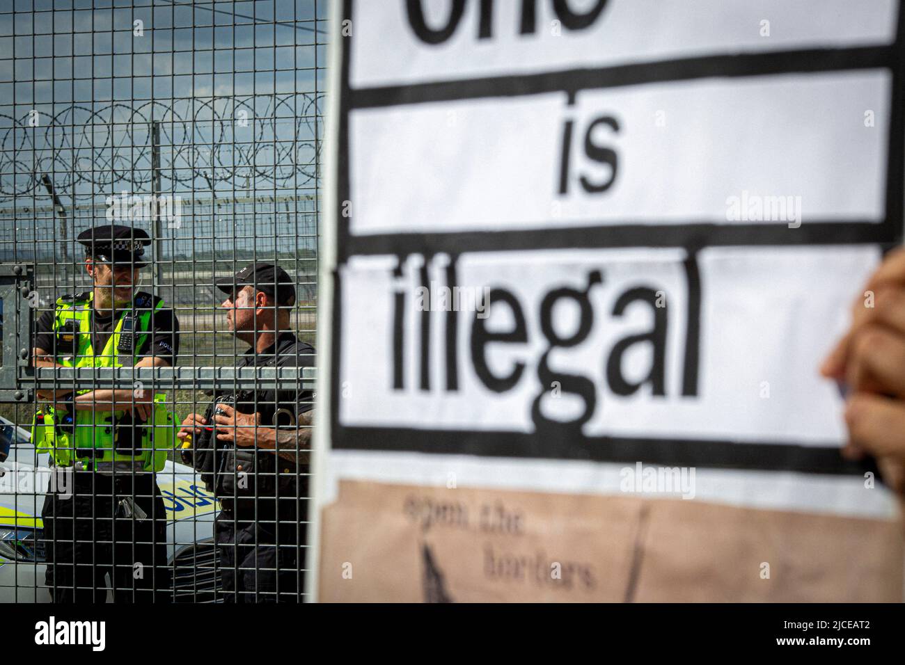 Police stand guard at a road block near Brook House Immigration Removal Centre on June 12, 2022 in London, England. Stock Photo