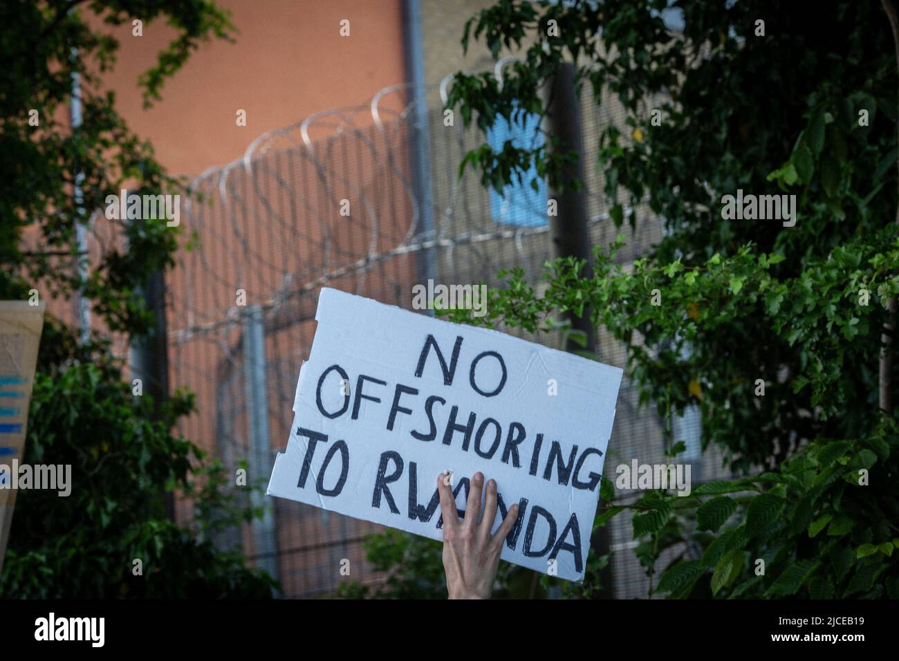 Placard against the UK deportation flights to Rwanda near Brook House Immigration Removal Centre on June 12, 2022 in London, England. Stock Photo