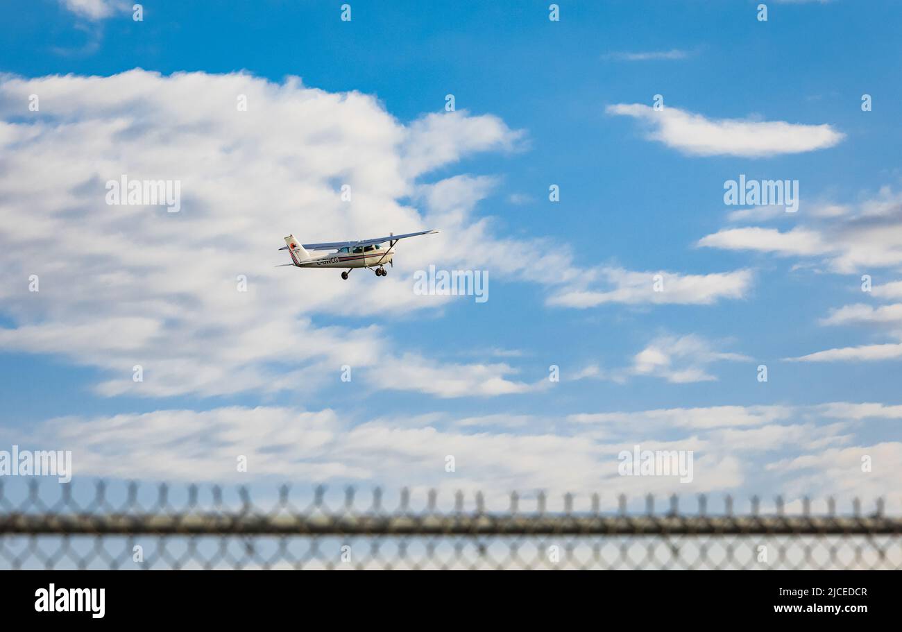 Light plane taking off from the airfield. Small airplane in the sky, student is learning how to take off and land on the ground. Travel photo, nobody, Stock Photo