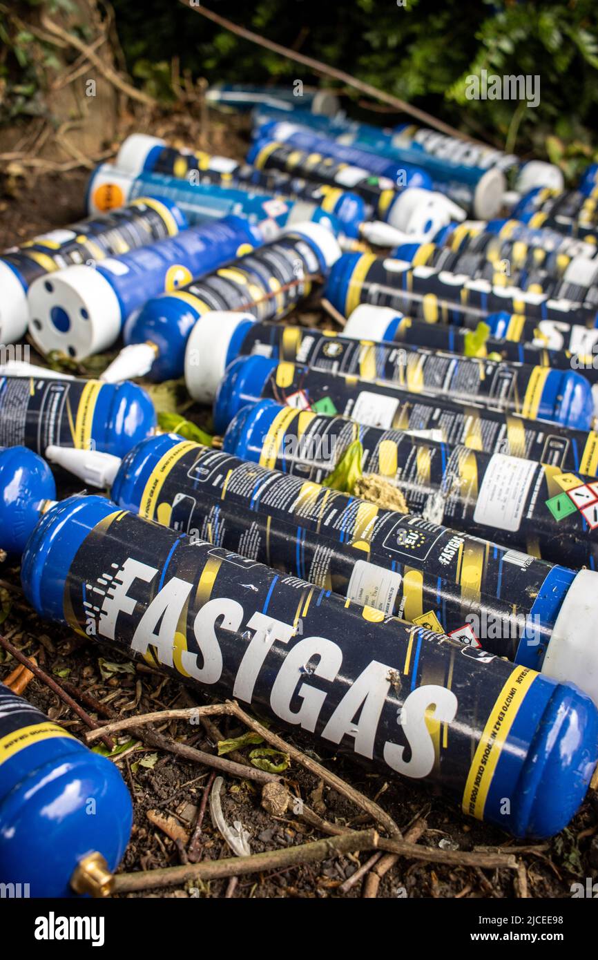 Cans of 'Fastgas' Nitrous Oxide (N2O) left discarded on a street in Bristol Stock Photo