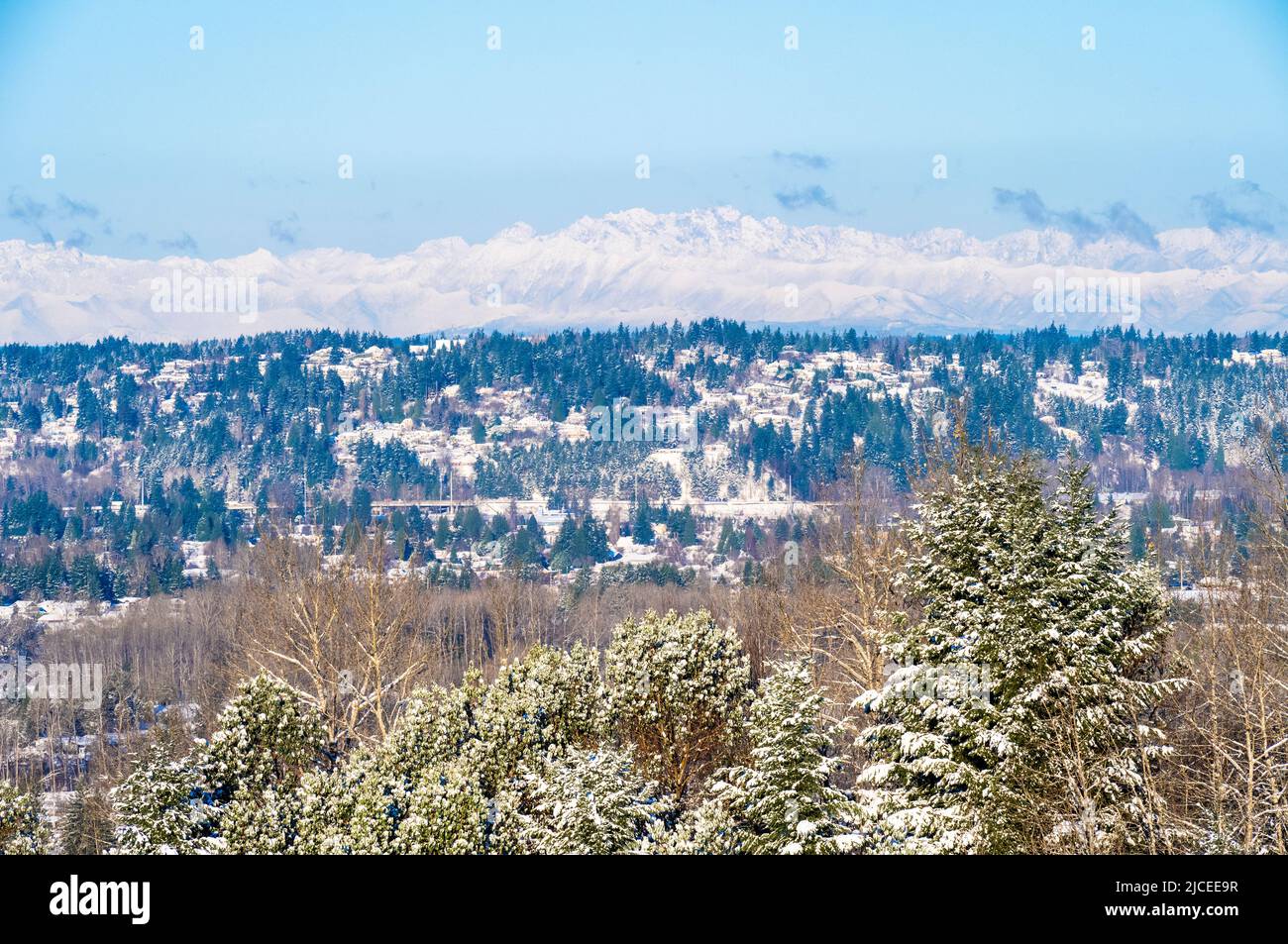 snow covered Olympic mountain range in the Washington state on a winter day with the Puyallup valley befow Stock Photo