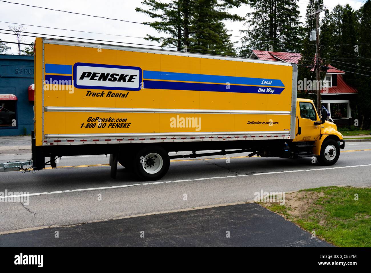 A Penske Truck Rental cargo van driving through Speculator, NY Stock Photo
