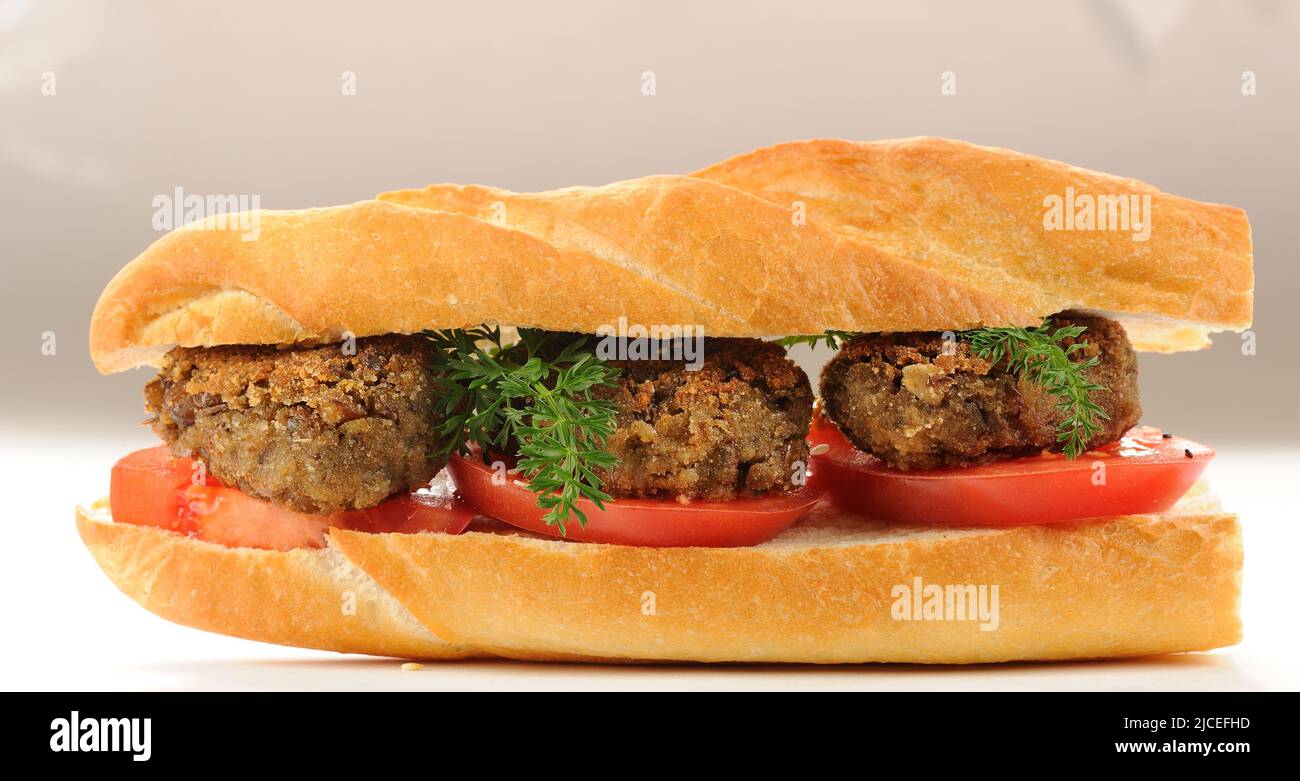 Lentil patty sandwich with tomato and carrot greens horizontal Stock Photo
