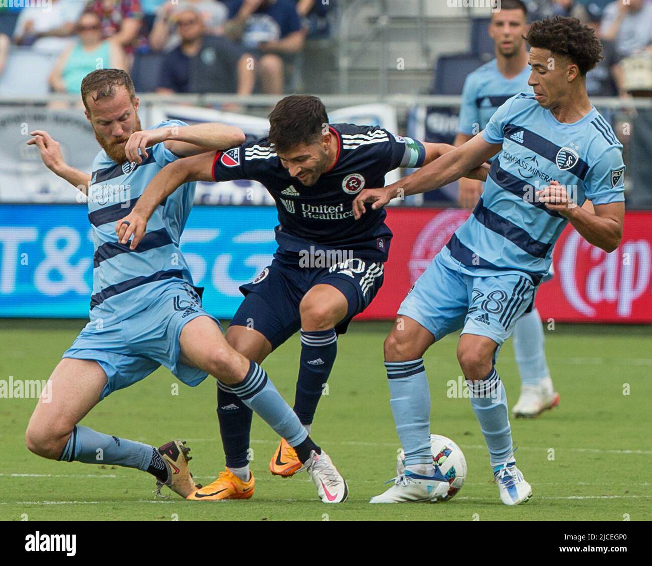 Kansas City, Kansas, USA. 11th June, 2022. The defense by New England Revolution midfielder Carles Gil #10 (c) is impeded by Sporting KC midfielders Oriol Rosell #6 (l) and Cameron Duke #28 (Credit Image: © Serena S.Y. Hsu/ZUMA Press Wire) Stock Photo