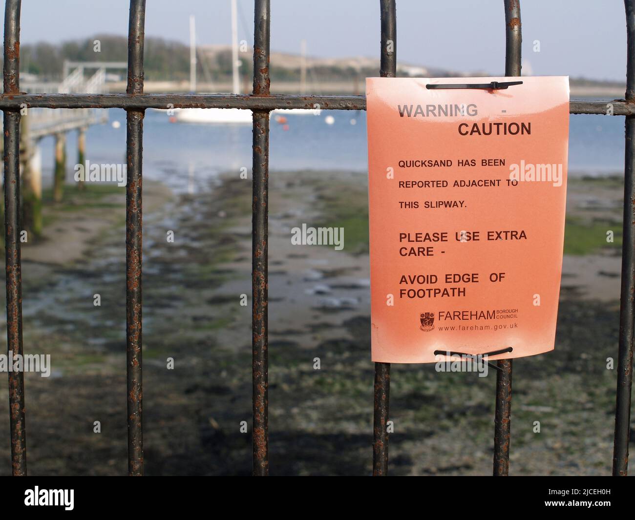 Quicksand notices posted on jetty at Portchester Castle, Portchester, Fareham, Hampshire, UK Stock Photo