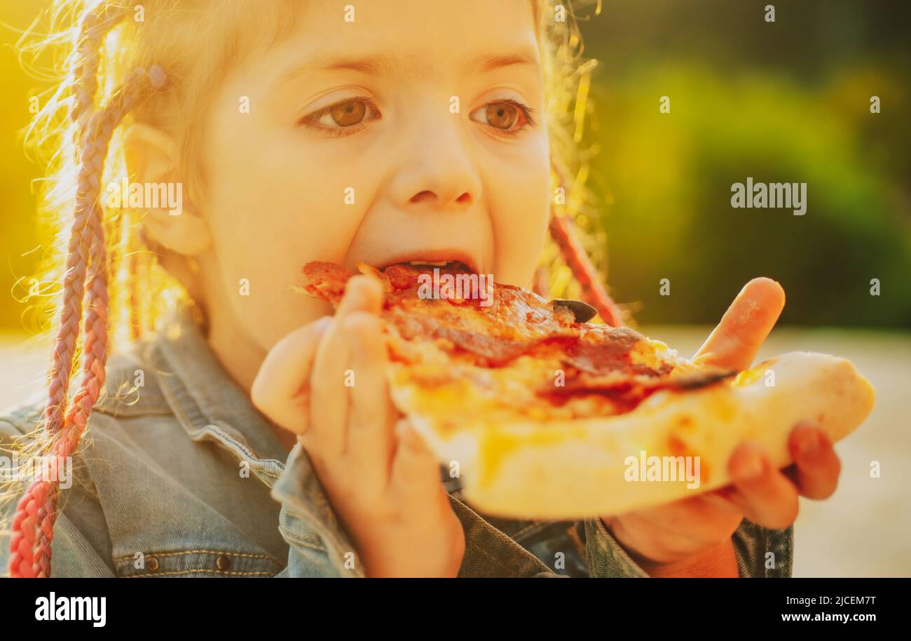 Kids favorite food. Tasty pizza. Child eating pizza. Fastfood. Italian