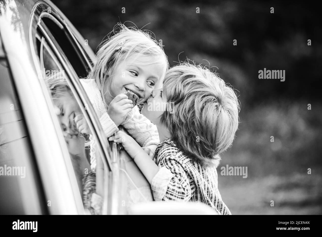Delighted happy smiling little girl says goodbye to little boyfriend