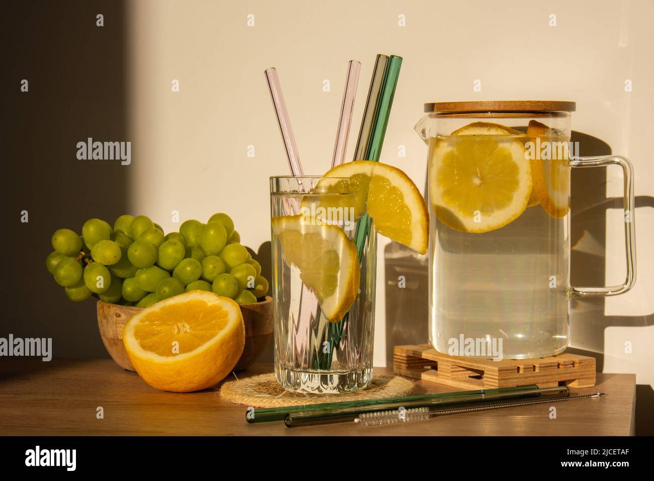 Glass of water with fresh lemon juice with Reusable glass Straws Detox