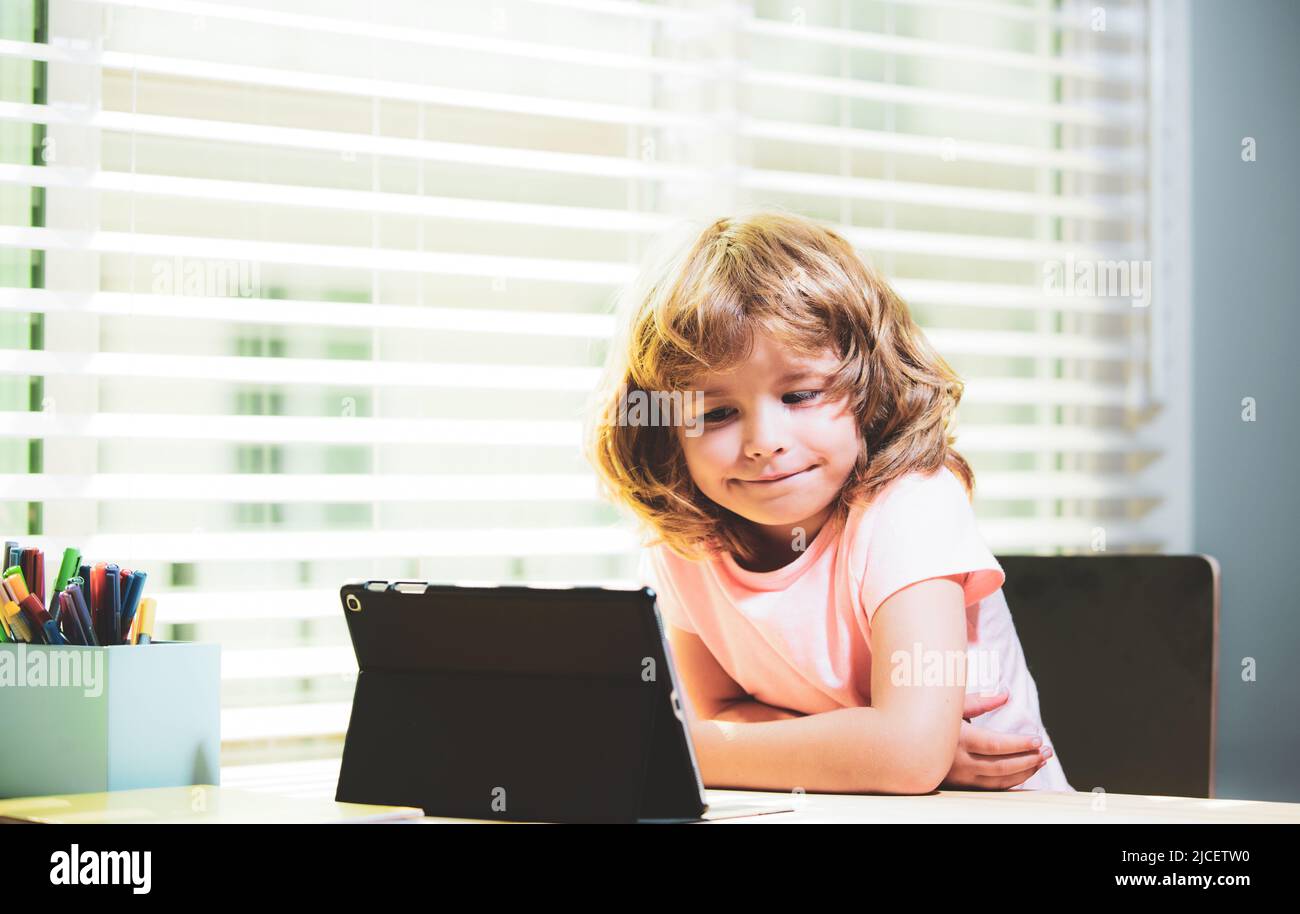 Child home schooling. Online school. Schoolboy doing her homework with ...