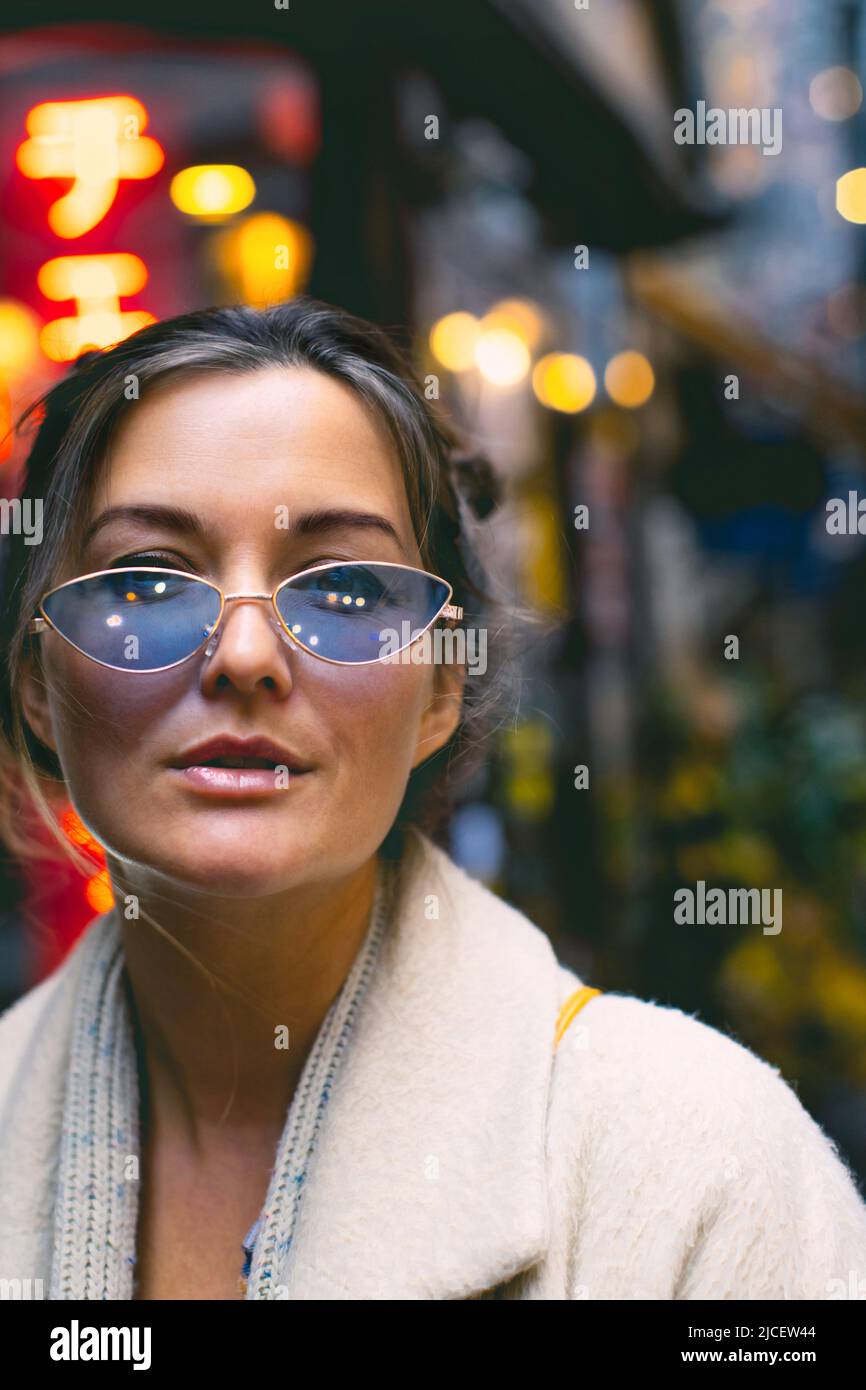 Portrait of an attractive woman wearing blue glasses in a Japanese