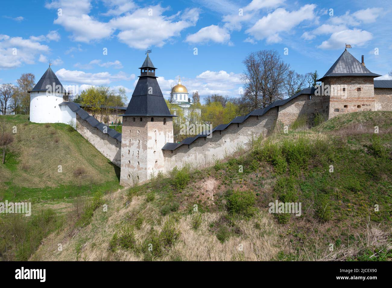 Sunny May day at the ancient walls of the Holy Assumption Pskov-Caves Monastery. Pechory, Pskov region. Russia Stock Photo