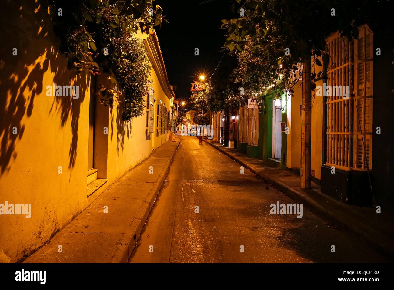 Iluminated empty street at night with colonial buildings in Cartagena, Unesco World Heritage Stock Photo