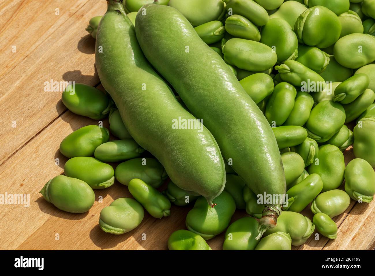 Both broad bean pods and shelled seeds. Healthy organic green raw broad beans Stock Photo Alamy
