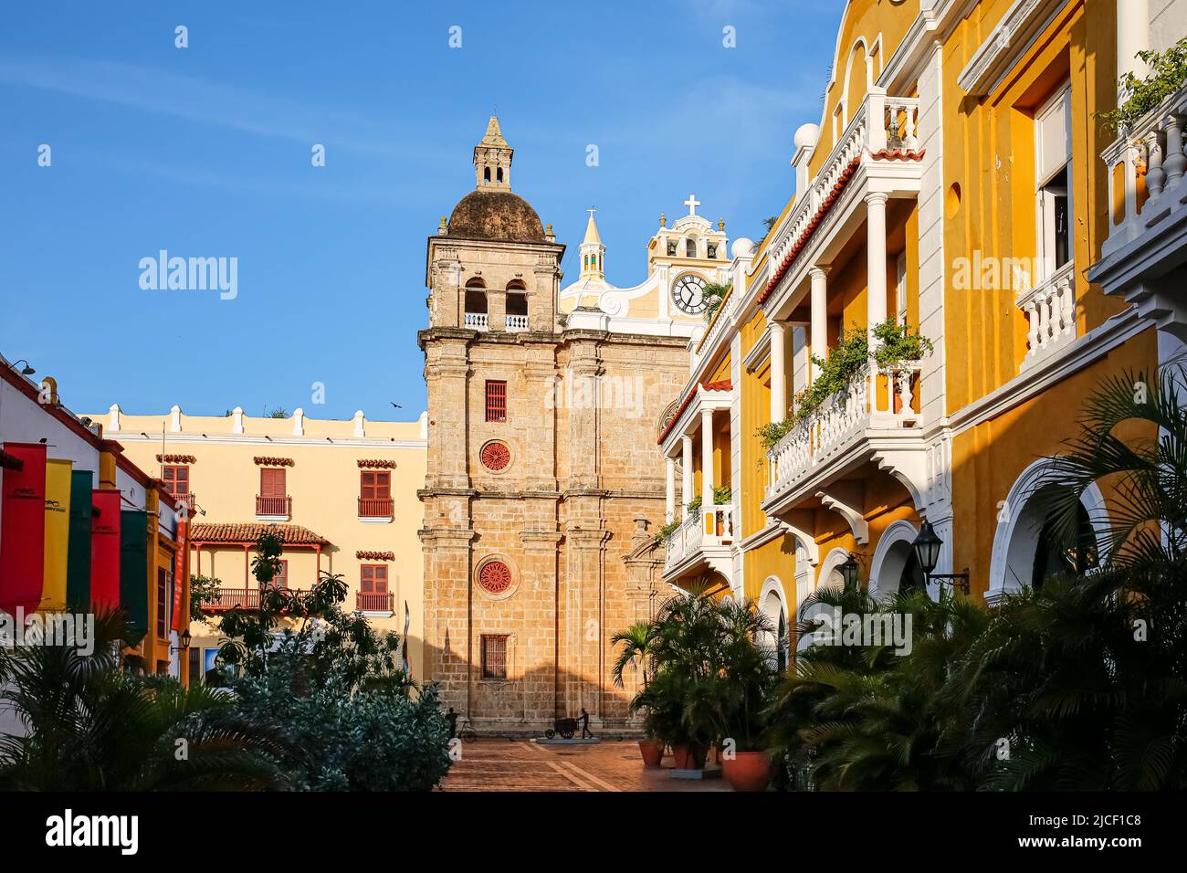 View to ensemble of impressive church San Pedro Claver and traditional colorful houses with blue sky, Cartagena, Colombia, Unesco World Heritage Stock Photo