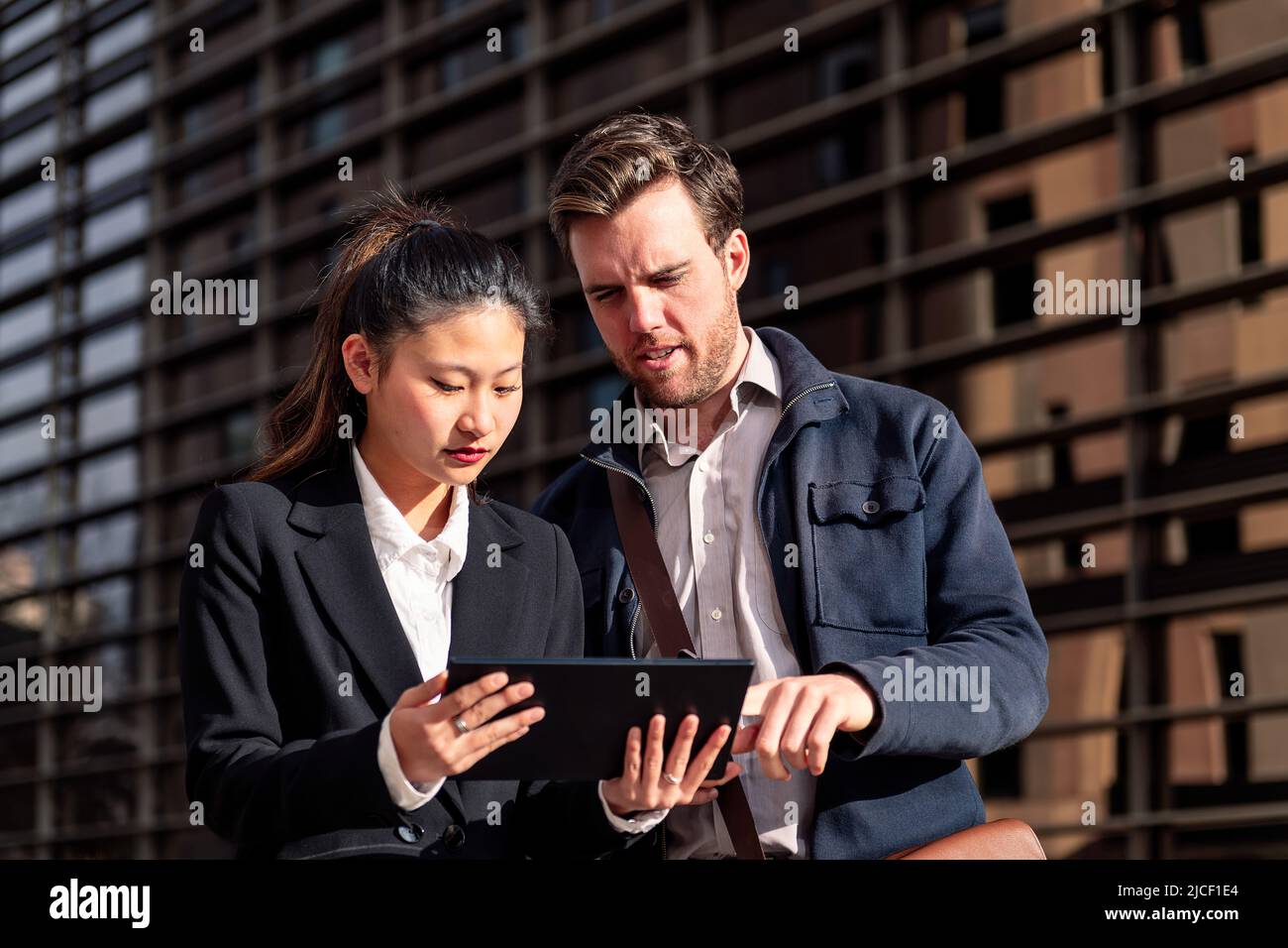 business woman showing tablet to entrepreneur man Stock Photo