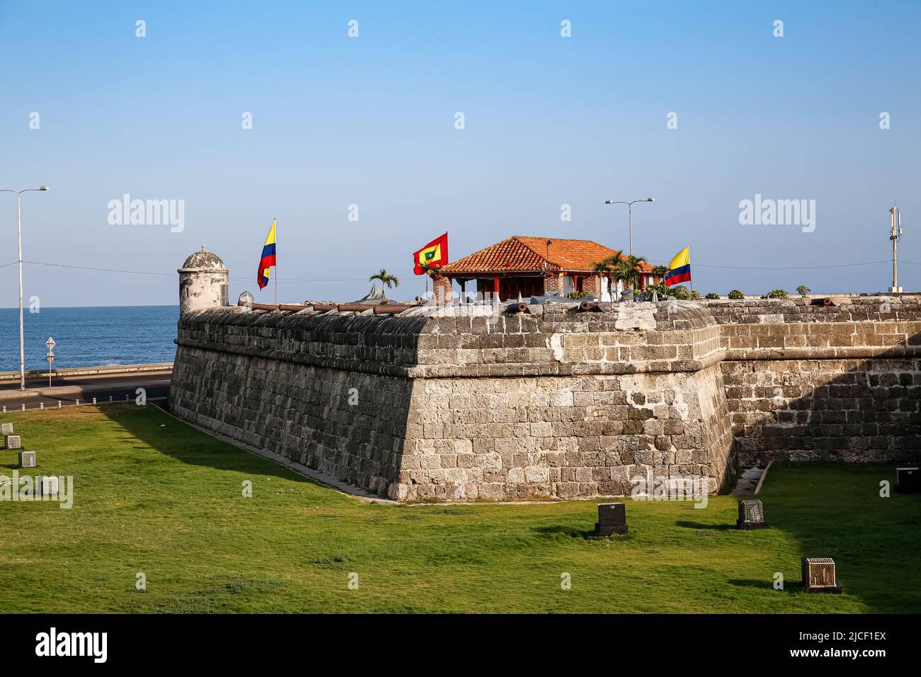View to a bastion of the city wall with blue sky and see in background, Cartagena, Colombia, Unesco World Heritage Stock Photo