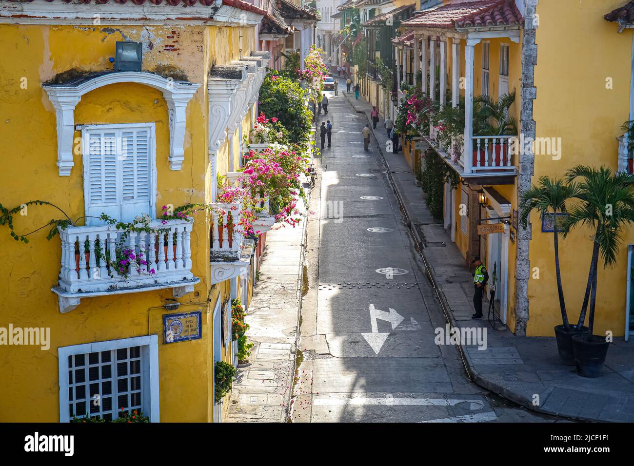 High angle view of a narrow street with historic houses with decorated balconies in sunshine, Colombia, Unesco World Heritage Stock Photo