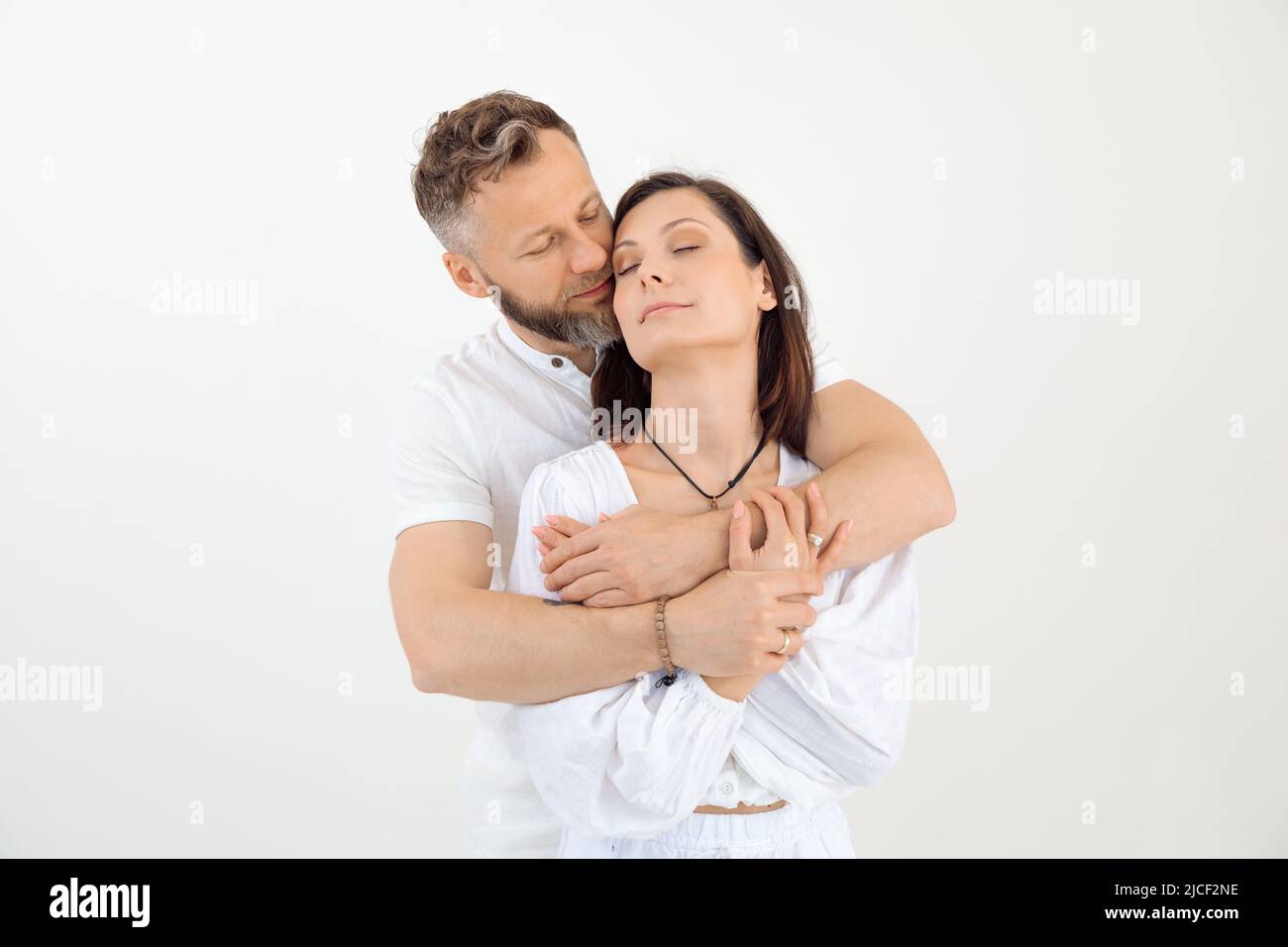 Man and woman, family stand together, embracing. Trust and love relationship. Male behind female, celebrate. Copy space Stock Photo