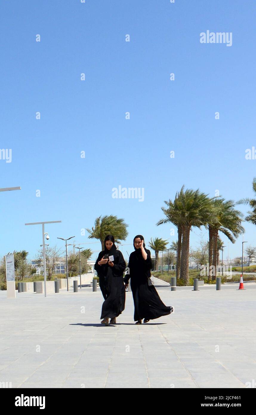 Emirati women walking on the Corniche waterfront promenade in Abu Dhabi, United Arab Emirates. Stock Photo