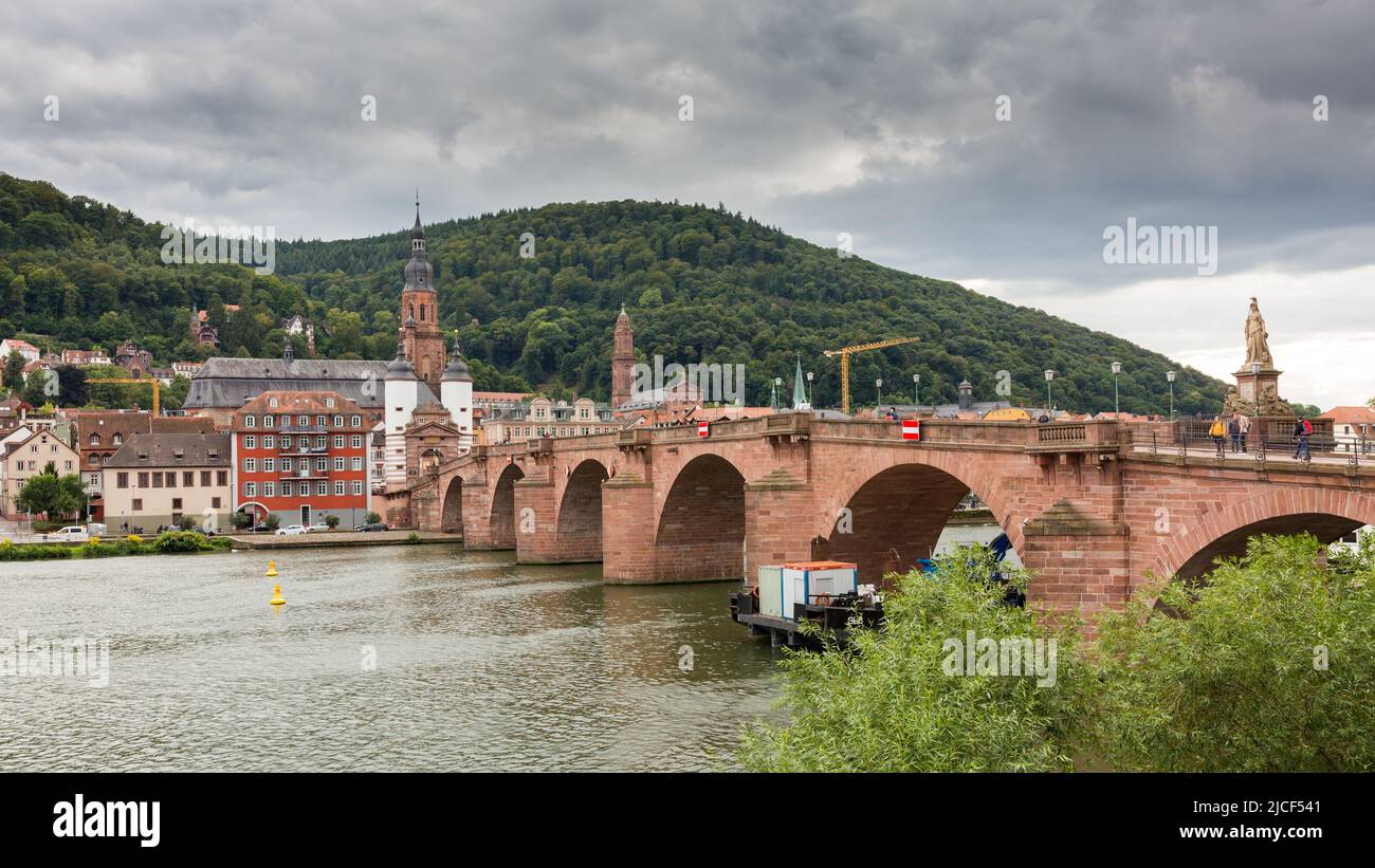 Heidelberg, Germany - Aug 26, 2021: Panorama with the old bridge (Alte Brücke). In the background the church of the holy spirit. Stock Photo