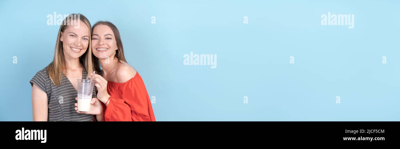 Cute Girl Is Having Fun With Her Stylish Mom In Red Dress Drinking 
