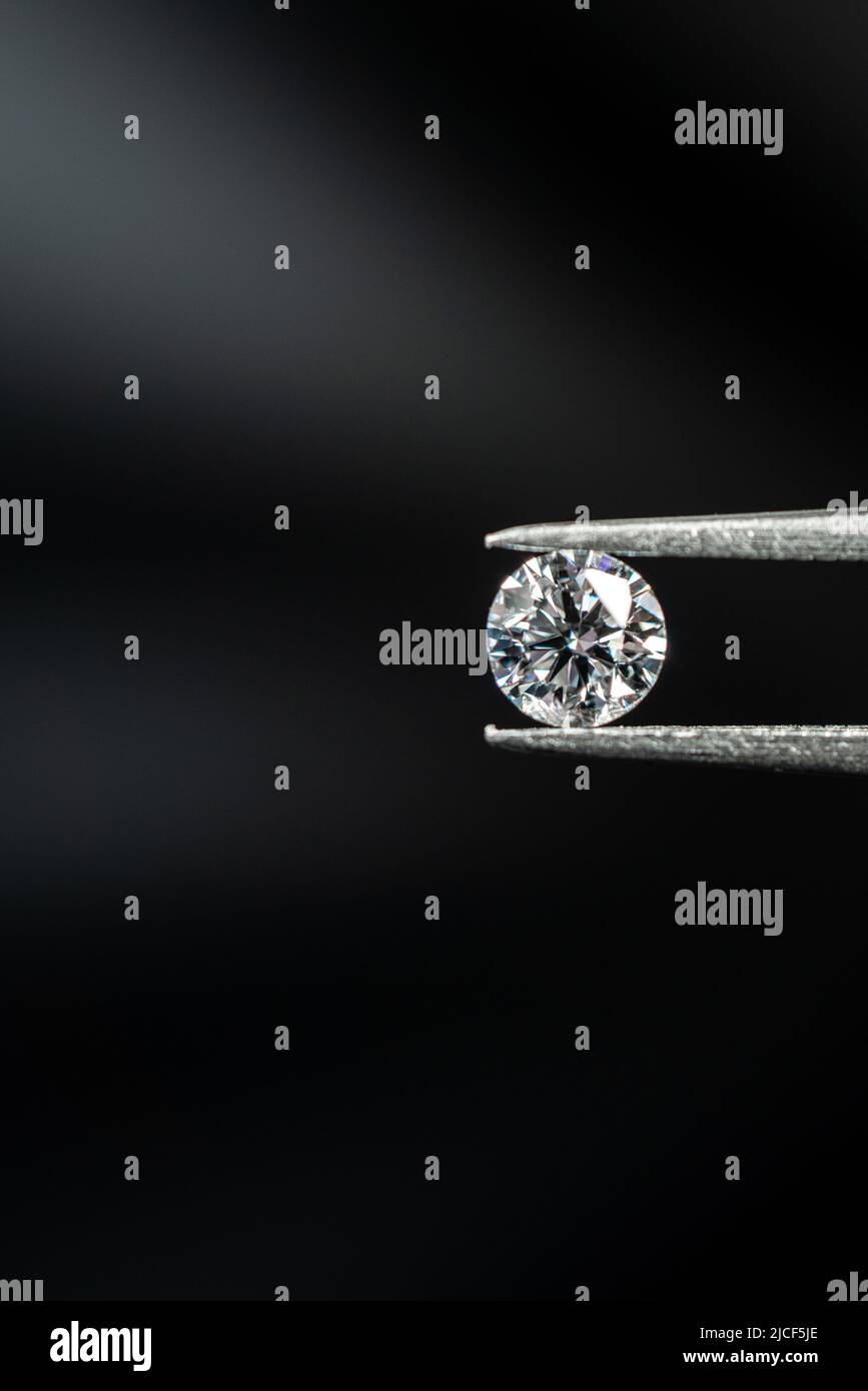 Round brilliant cut diamond with tweezers Stock Photo Alamy