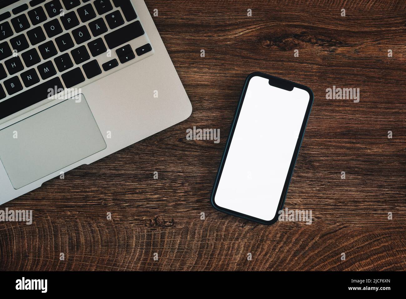 Empty notepad and modern smart phone mockup on white office desk surrounded  with office supplies. Top view. Flat lay Stock Photo - Alamy