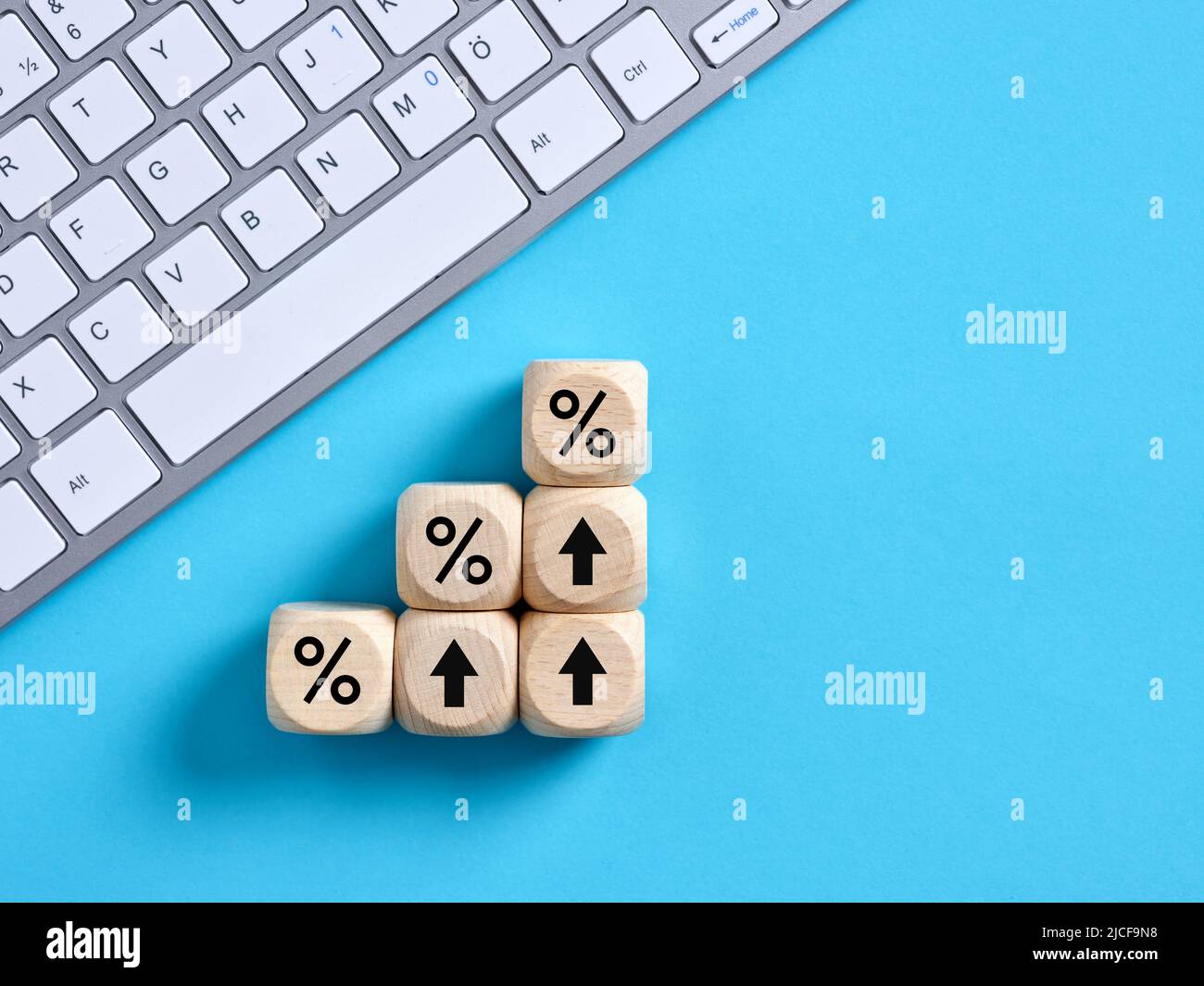 Percent or percentage symbols on wooden cubes. Calculating increasing financial interest rates or mortgage rates concept. Stock Photo