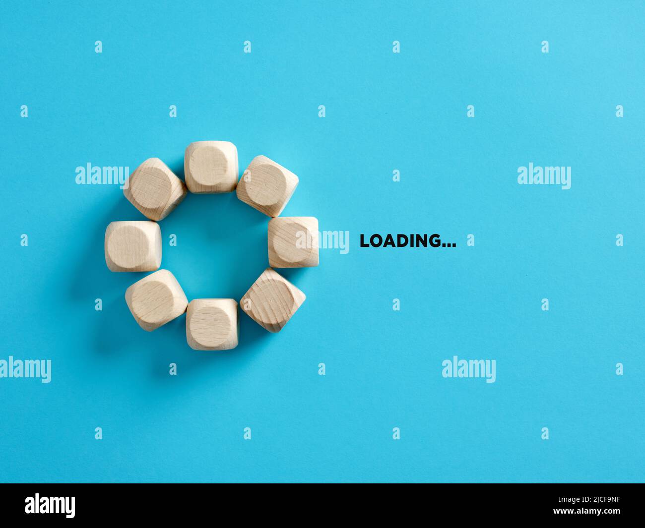 Wooden cubes with the word loading in loading progress indicator bar. Stock Photo