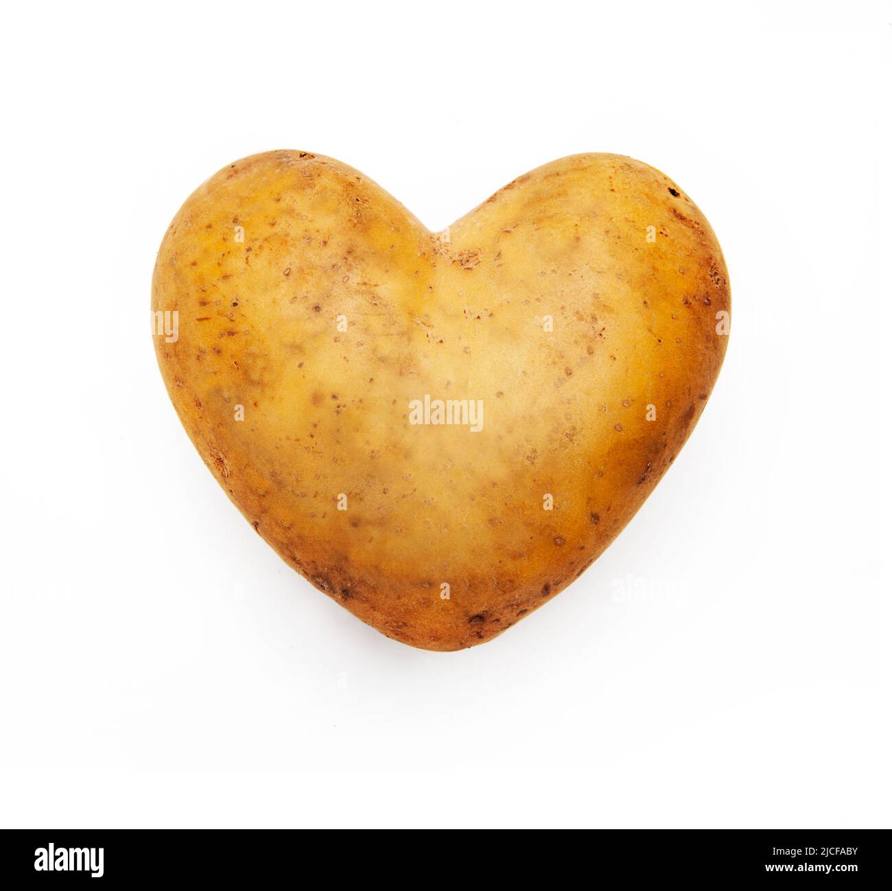 Potato in heart shape isolated on white background Stock Photo - Alamy
