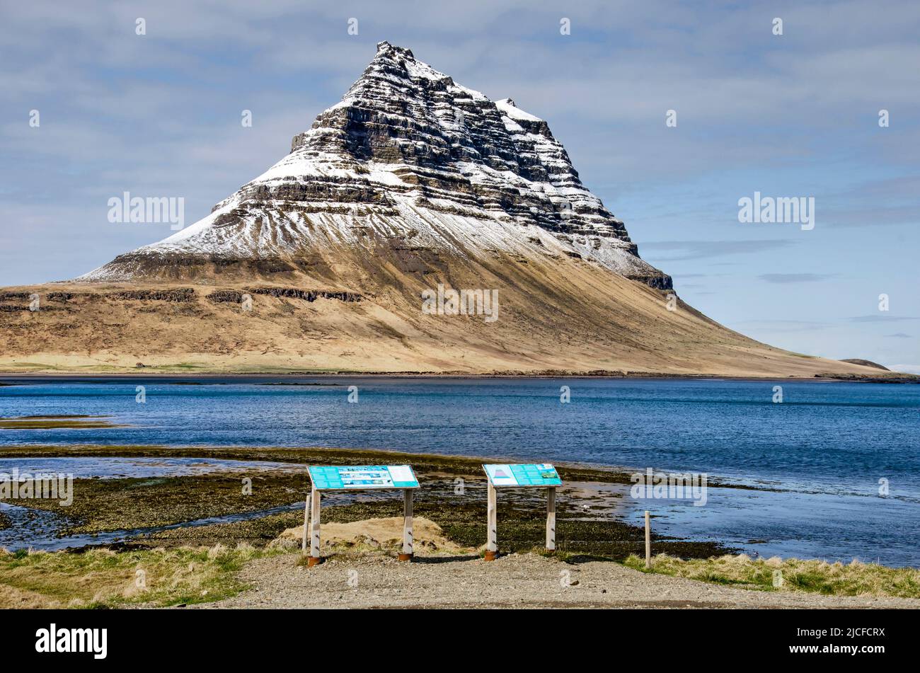 Grundarfjörður, Iceland, May 6, 2022: information panels along the coastal road, with the iconic Kirkjufell (Church Mountain) in the background Stock Photo