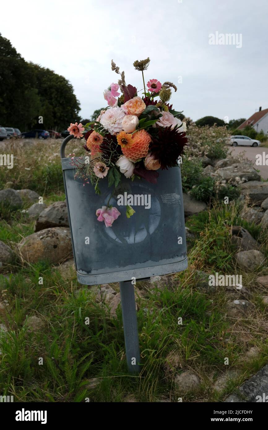 Sweden, Scania, Skane, wedding, bouquet of flowers in a trash can Stock