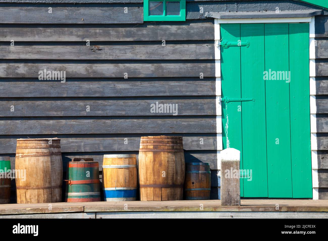 Wooden Barrels beside a Door, Zaanse Schans Open-Air Museum, Zaandam, North Holland, Netherlands Stock Photo