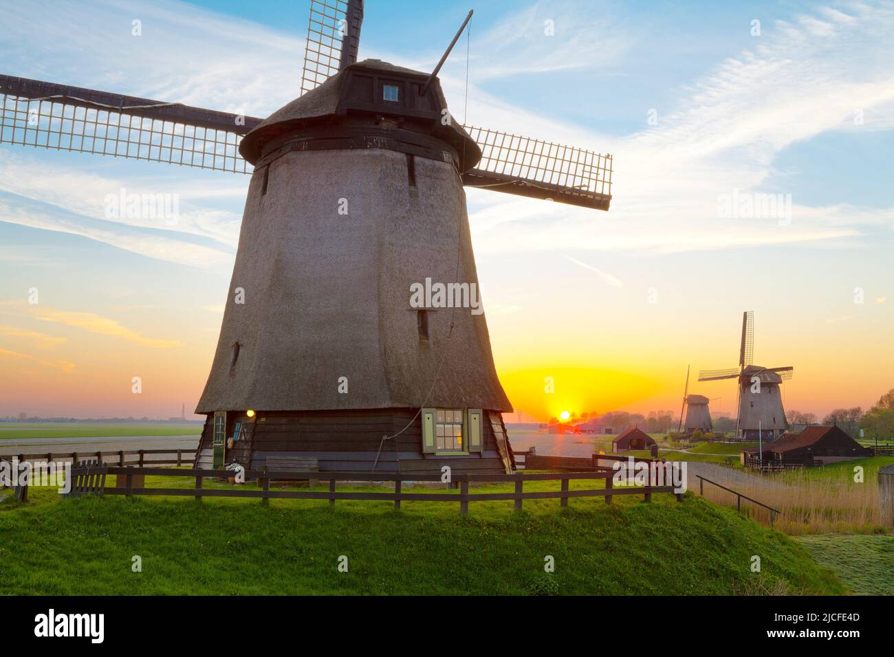 Traditional Windmills at sunset, Schermerhorn, North Holland, Netherlands Stock Photo