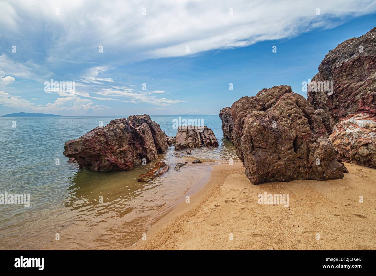 Sea side landscape with rock formations at the beach of Pantai Dendong ...