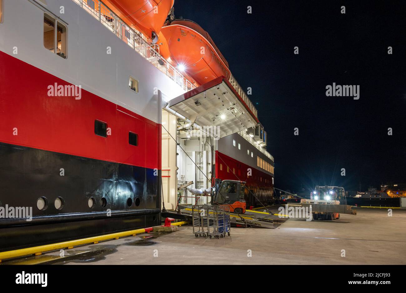 Norway, Troms og Finnmark, loading goods onto the Hurtigruten ship 'Nordlys'. Stock Photo