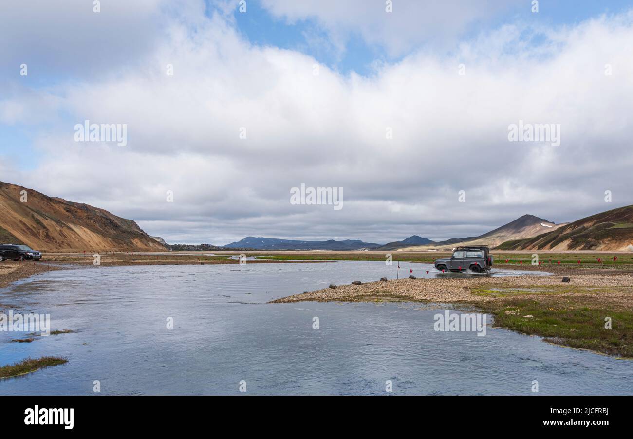 Laugavegur hiking trail is the most famous multi-day trekking tour in Iceland. Landscape shot from the area around Landmannalaugar, starting point of the long-distance hiking trail in the highlands of Iceland. River crossing. Stock Photo