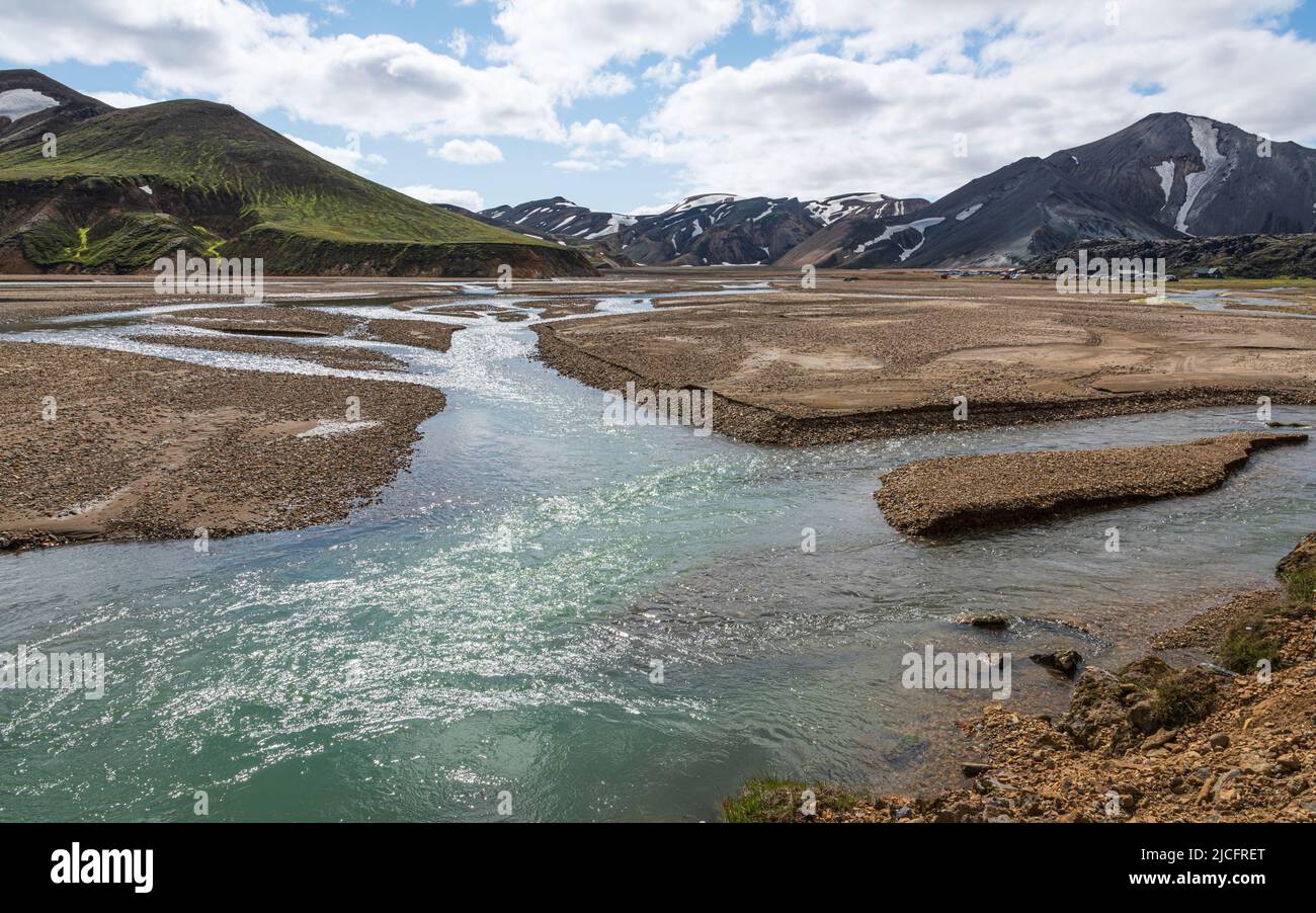 Laugavegur hiking trail is the most famous multi-day trekking tour in Iceland. Landscape shot from the area around Landmannalaugar, starting point of the long-distance hiking trail in Iceland's highlands. River. Stock Photo