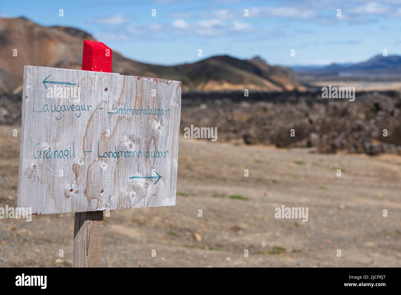 Laugavegur hiking trail is the most famous multi-day trekking tour in Iceland. Landscape photo from the area around Landmannalaugar, starting point of the long-distance hiking trail in the highlands of Iceland near the volcano Hekla. Signpost Graenagil made of wood, handwritten. Stock Photo