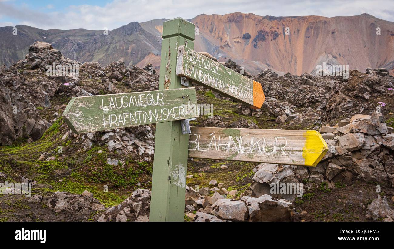 Laugavegur hiking trail is the most famous multi-day trekking tour in Iceland. Landscape photo from the area around Landmannalaugar, starting point of the long-distance hiking trail in the highlands of Iceland near the volcano Hekla. Signpost in the lava field. Stock Photo