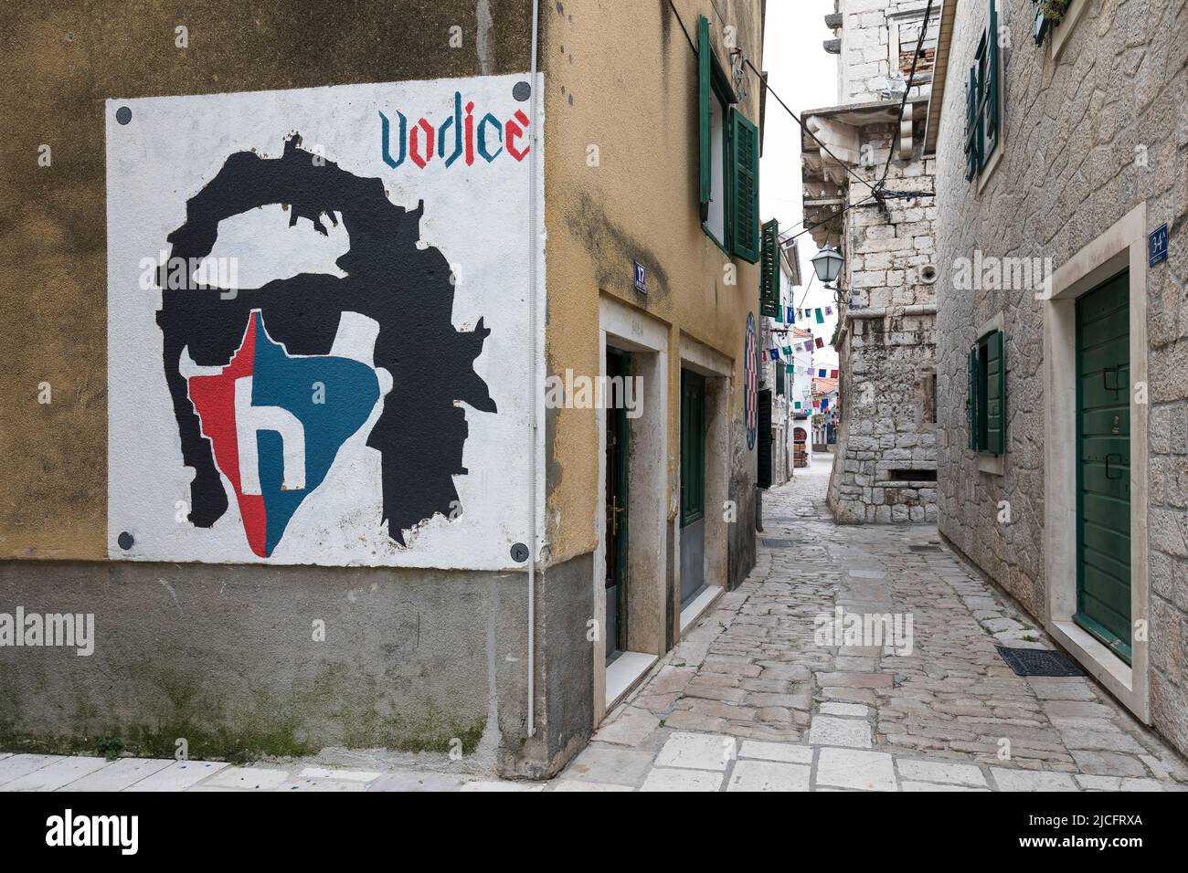 Wall painting and narrow alley in small town Vodice, Sibenik-Knin County, Central Dalmatia, Croatia, Europe Stock Photo